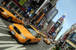 Hospitality News: NEW YORK - AUGUST 28: Yellow taxi cabs rush tourists around Times Square on August 28, 2009 in New York City, NY