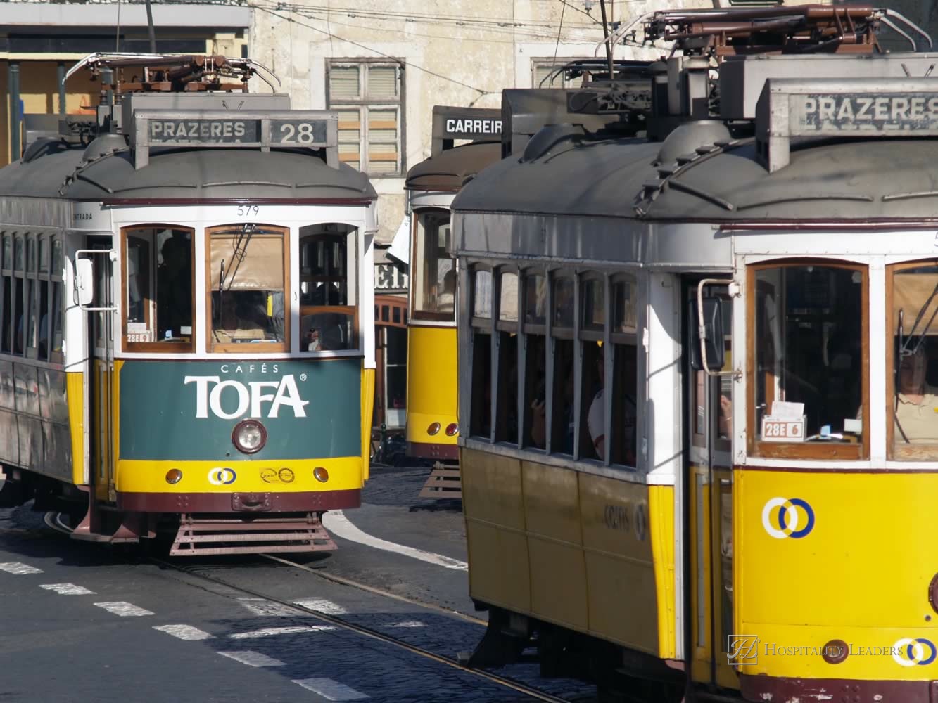 LISBON, PORTUGAL - AUGUST 11: Traditional yellow and red trams downtown Lisbon on August 11, 2009. Trams are used by everyone and also keep the traditional style of the historic center of Lisbon