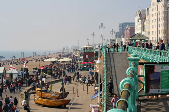 BRIGHTON,UK-MARCH 31:Visitors enjoy the beach March 31,2011 in Brighton.The seafront is full of bars and restaurants and being less than an hour from London has made the city a popular destination