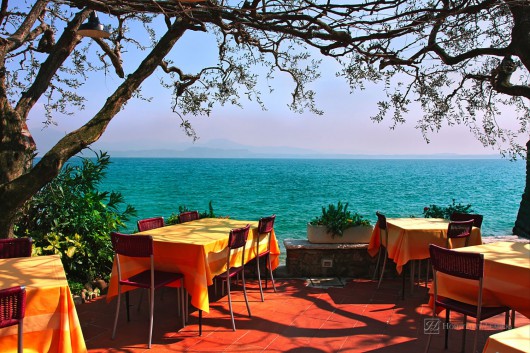 An outdoor restaurant with beautiful view on Lake Garda in Sirmione, Italy