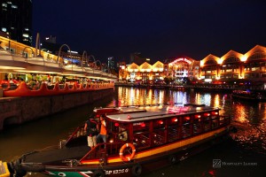 Hospitality News: Singapore - December 3: A river cruise boat picks up tourists at Clarke Quay jetty on the Singapore River December 3, 2010 in Singapore. The Singapore river cruise ride is a popular tourist attraction