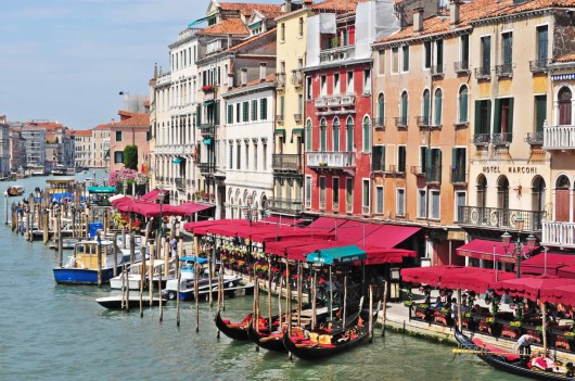 Venice, Italy - June 19: Tourists traveling on gondola and vaporetto water bus on Grand Canal on June 19, 2011 in Venice, Italy. Venice has an average of 50,000 tourists a day