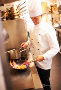 Hospitality News: Male chef cooking food in commercial kitchen