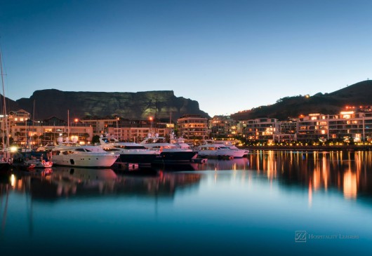 Victoria and Alfred Waterfront as the hot summers sun sets behind Table Mountain and the night lights start to shine