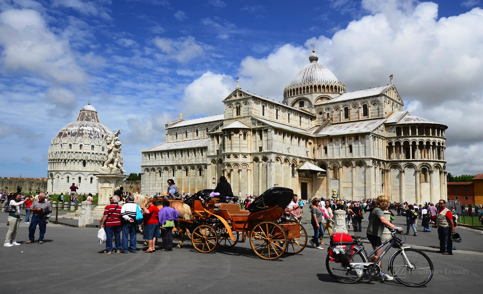 Pisa, Italy - June 11: crowd of tourists and horse coach on the Unesco World Heritage site Piazza dei Miracoli with Dome and Baptistery on June 11, 2012 in Pisa, Italy