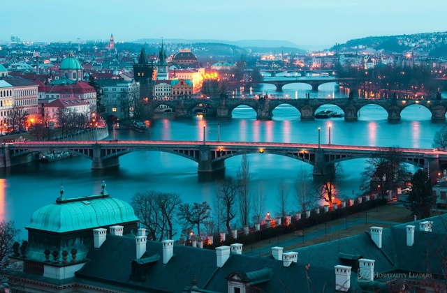 Panoramic view on Charles bridge and evening Prague lights. Beautiful famous place in Bohemia